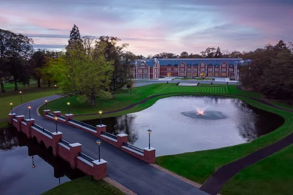 Fairmont Windsor Park — the red-brick hotel with its lake and grounds at dusk